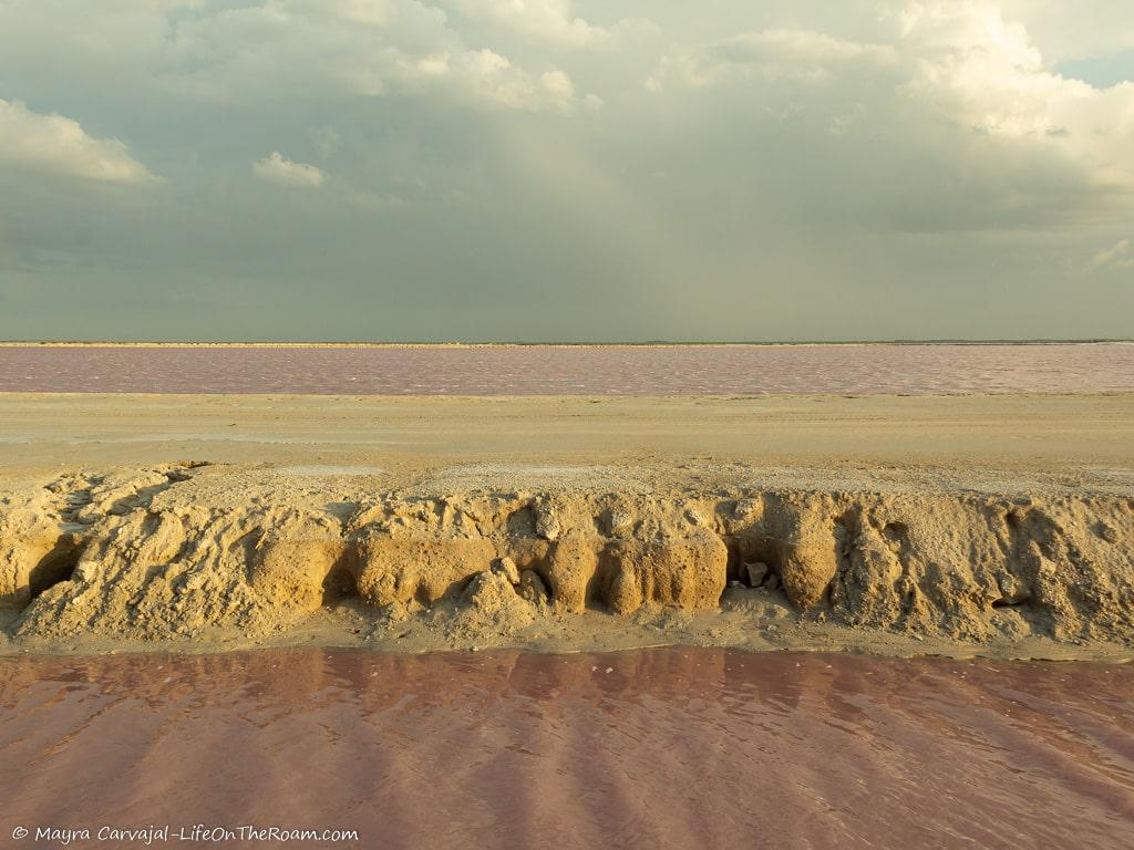 A moat with pink water