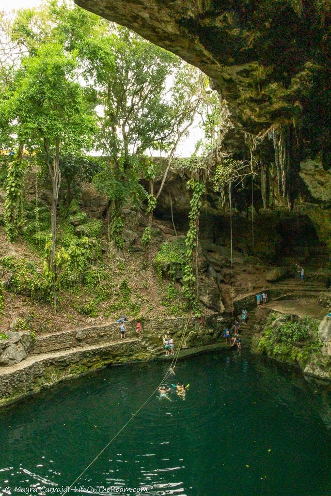 A cenote with people swimming