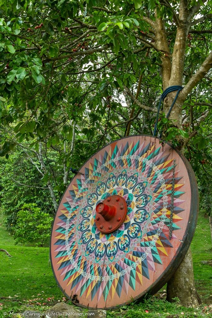 A decorated giant wheel leaning against a tree