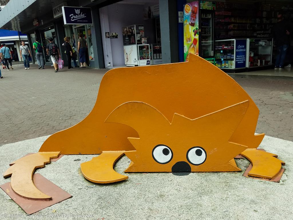 A sculpture of a dog lying down