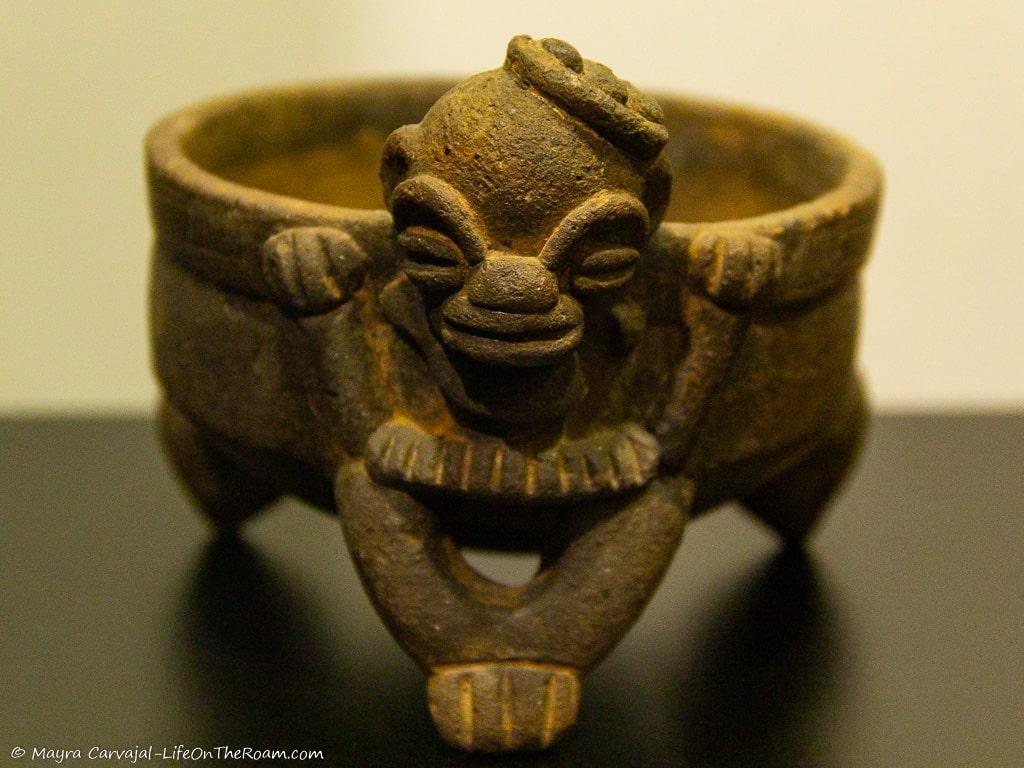 A bowl in clay with a fantastic figure
