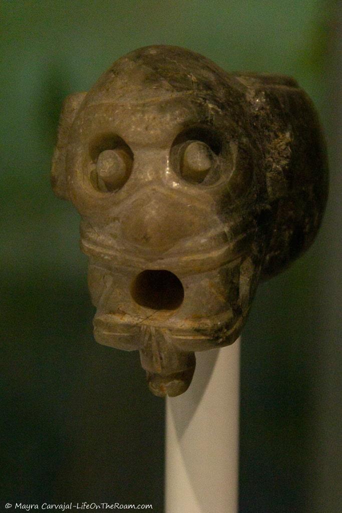 A small mask carved in jade depicting a face