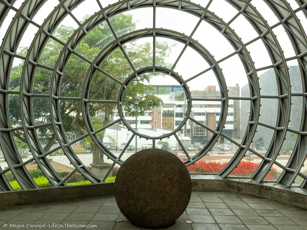 A stone sphere in a glass and metal sphere room