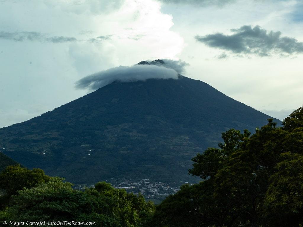 A volcano with clouds on top