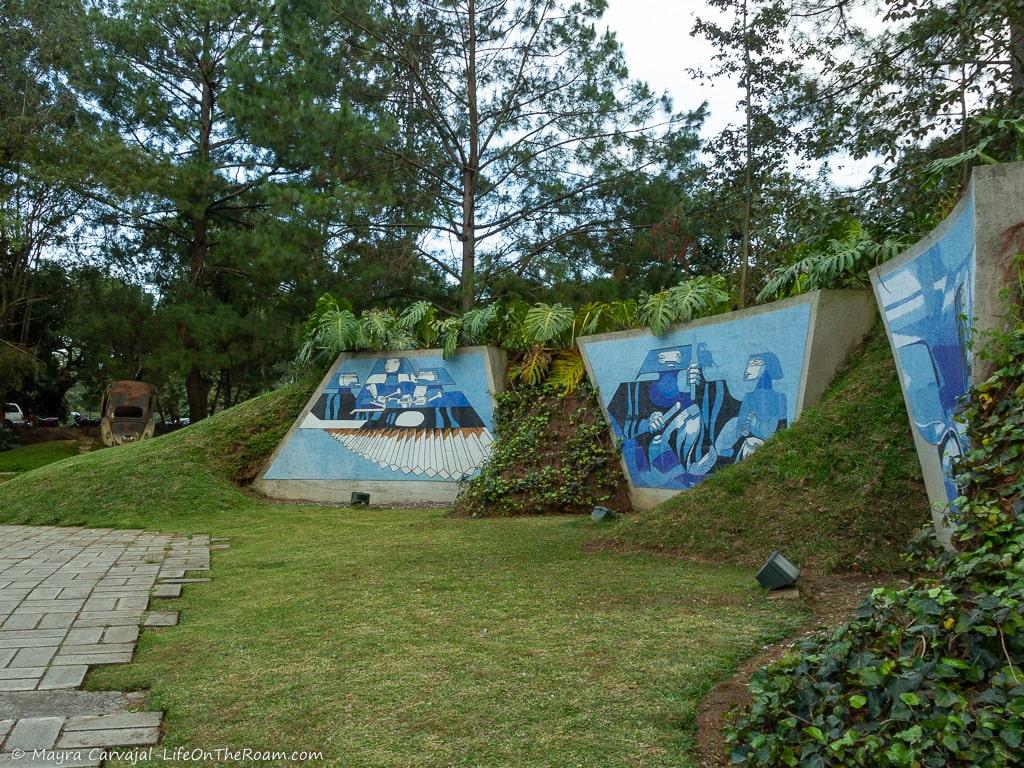 A wall mosaic in blue tones in the slope of a hill