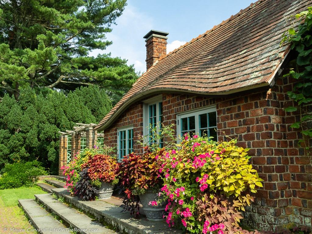 A quaint house with flower pots in the front