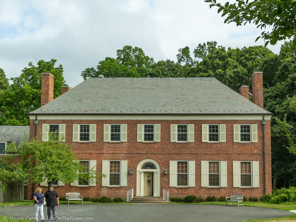 A brick 2-storey house with many windows