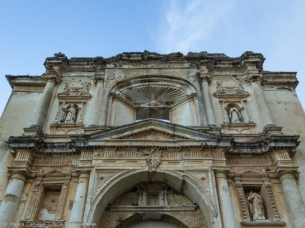 The façade of a temple with niches, pediments, and statues