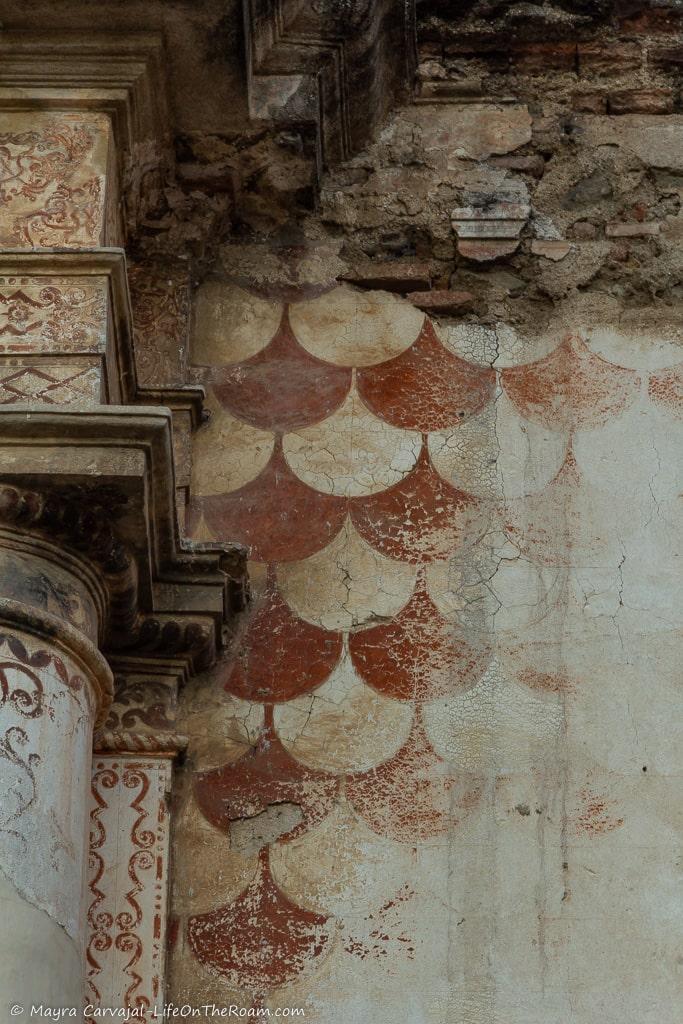 A geometric pattern on a wall in reddish tones