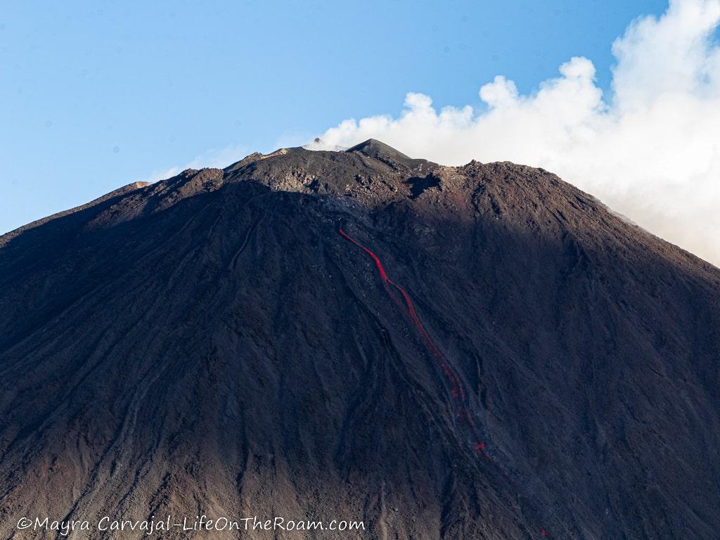 View of a volcano crater with a lava flow