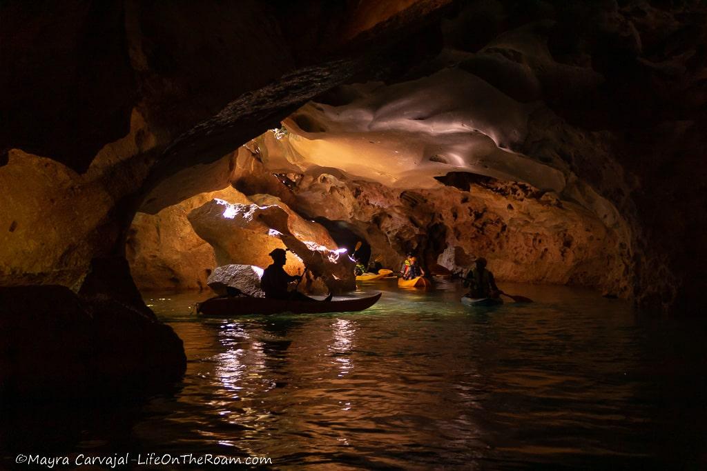 People kayaking inside a cave