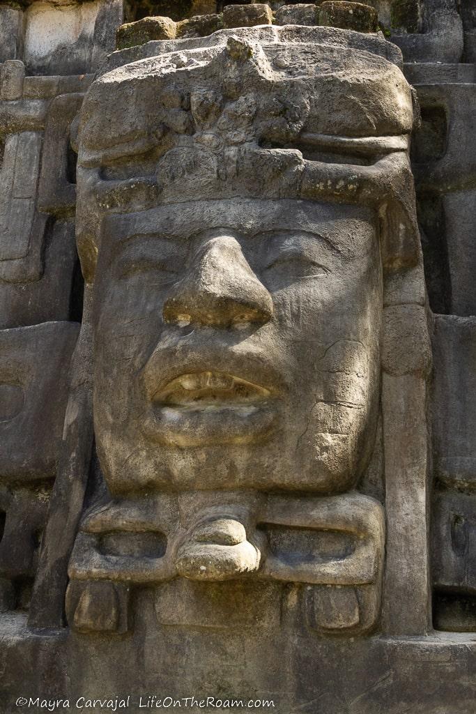 A big plaster mask in a building depicting a human face