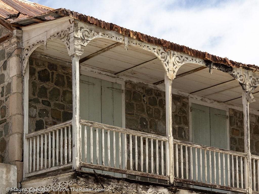The porch of a traditional Caribbean house with a stone façade