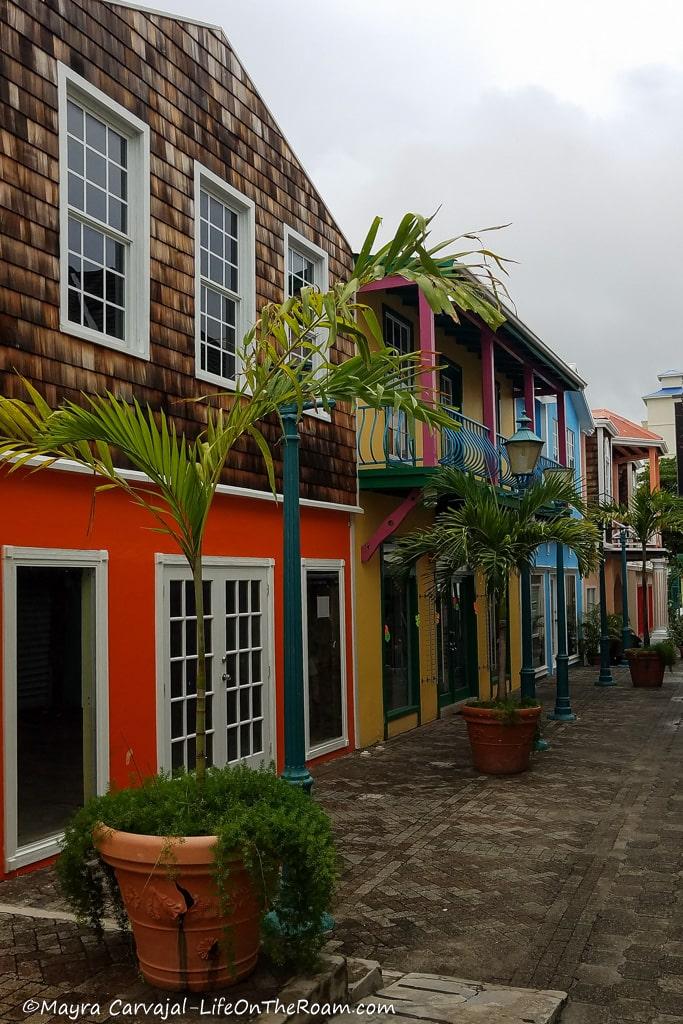 Colourful traditional buildings facing a brick street with palm trees
