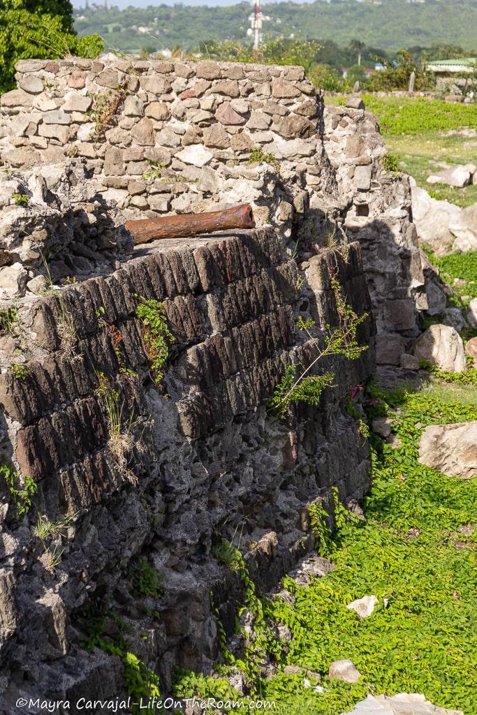 A wall made of stones with an old cannon