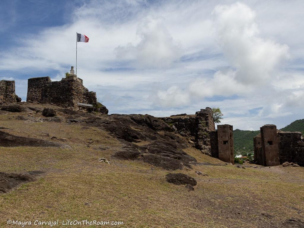 An abandoned fort with the French flag at the top