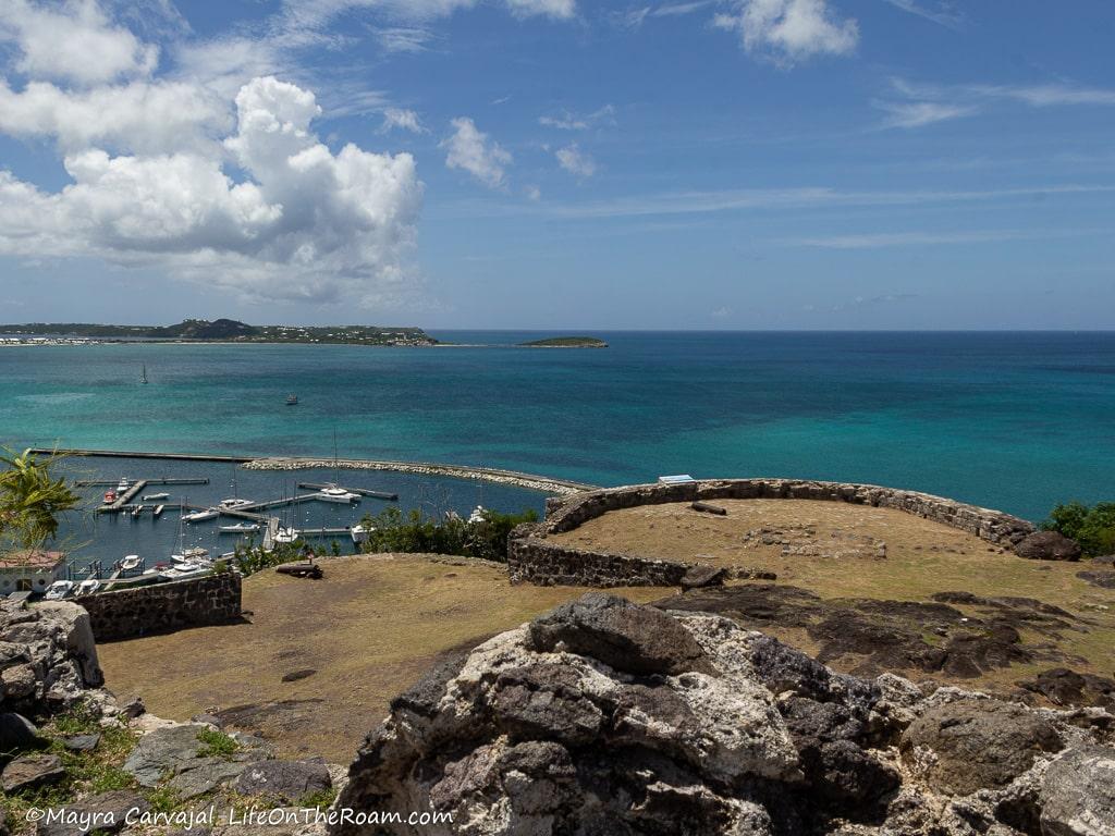 View of a fort walls, canons, and a bay.