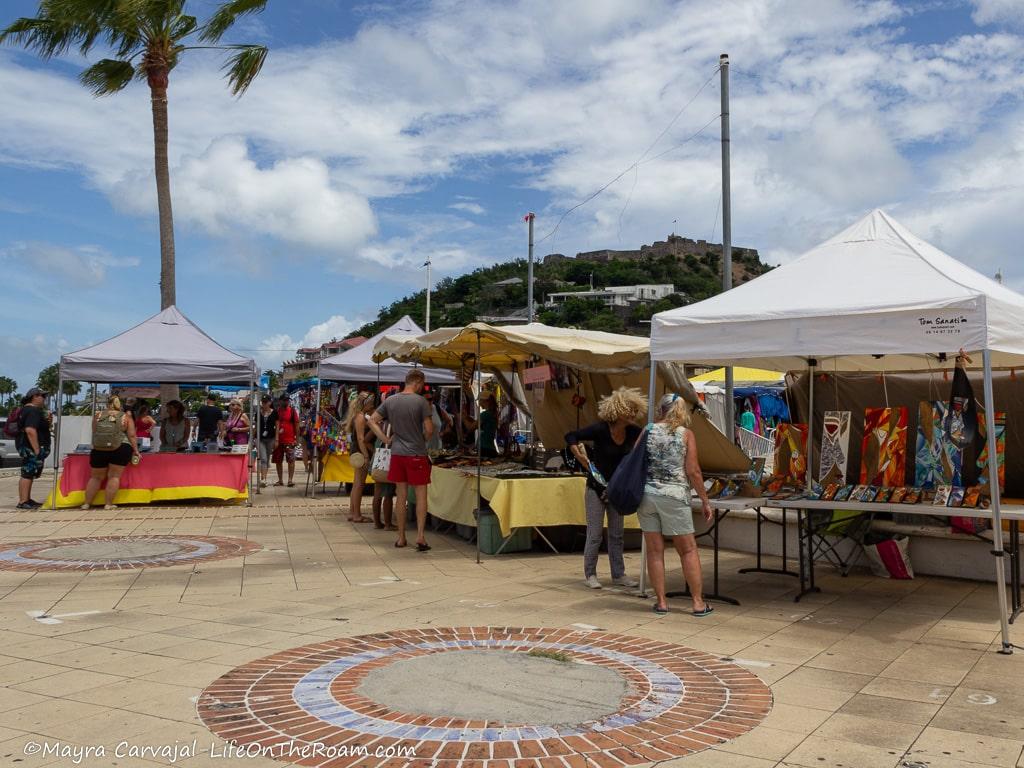 People browsing stalls at an open air market