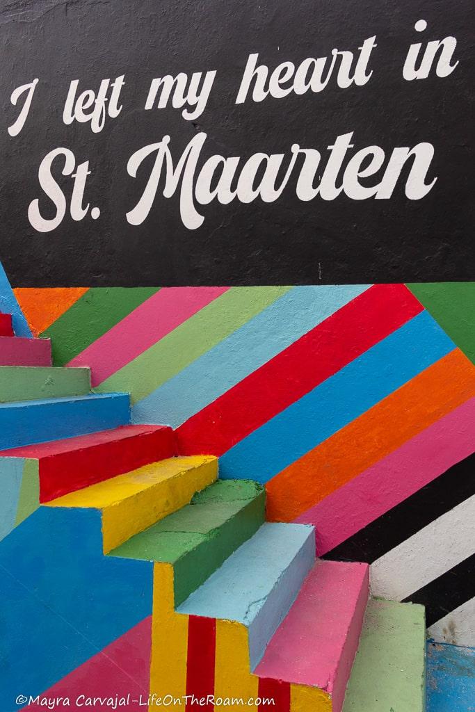 A colourful mural painted on stairs with the text "I left my heart in St.Maarten"