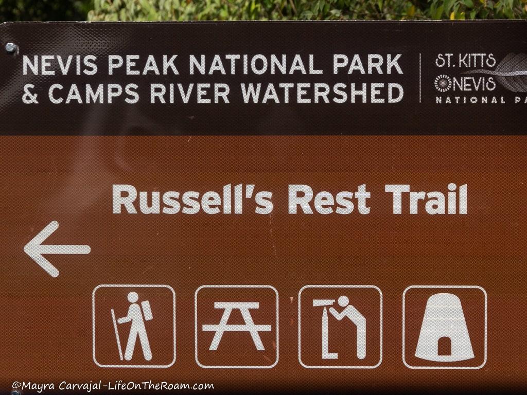 A trailhead sign reading "Russell's Rest Trail" and trail signs