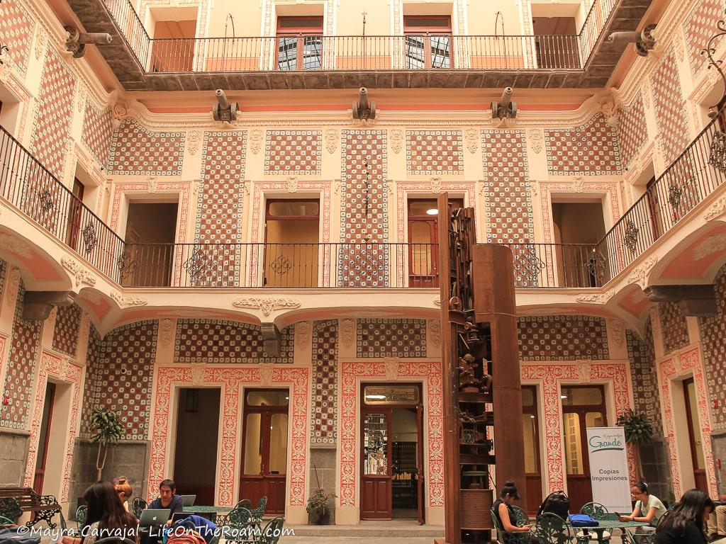 The decorated interior of a three-story houses with gargoyles in the shape of canons