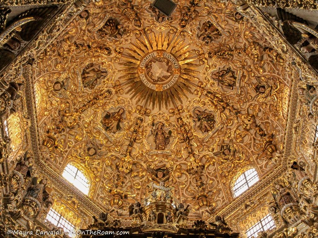 An ornate dome in a church with a dove representing the Holy Spirit in the centre