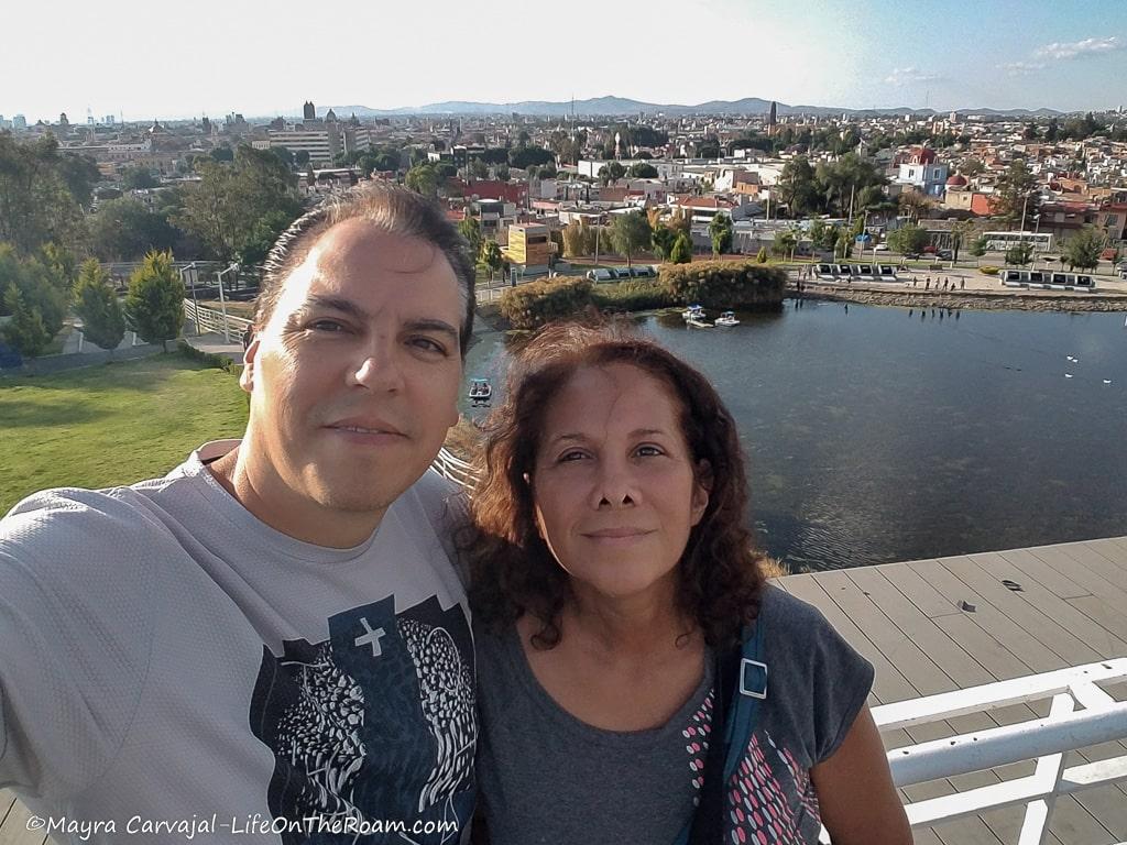 Mayra and Andre at a lookout above a lake