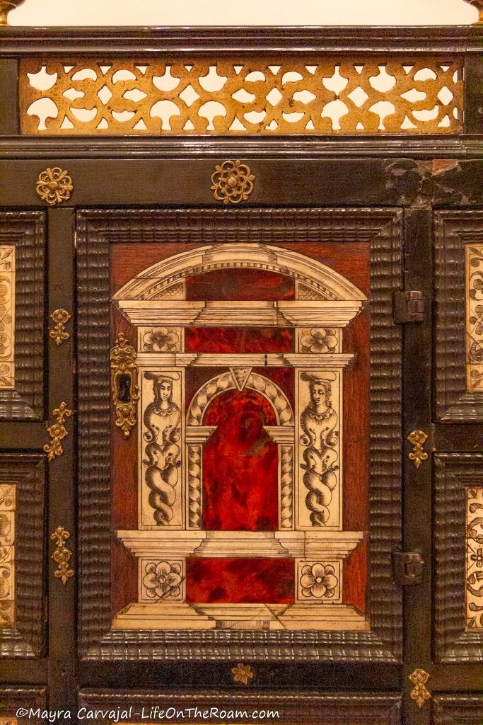 Door of a compartment of a desk organizer from the 17th century in wood and iron details