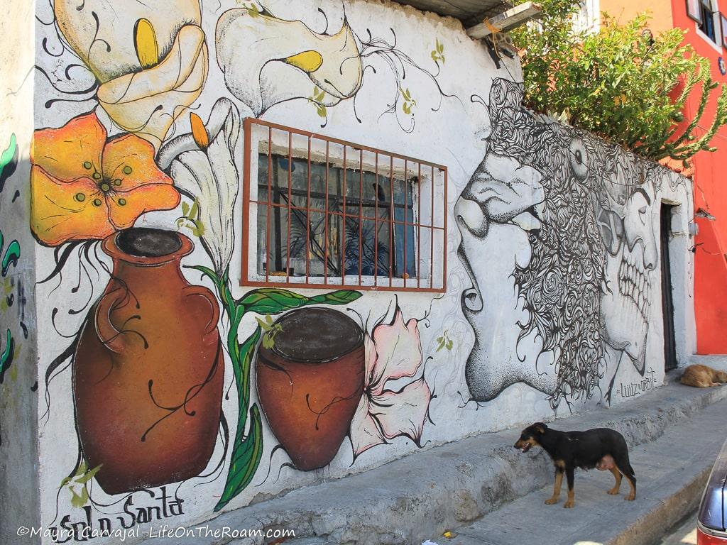 A mural with pots of flowers and human-like faces