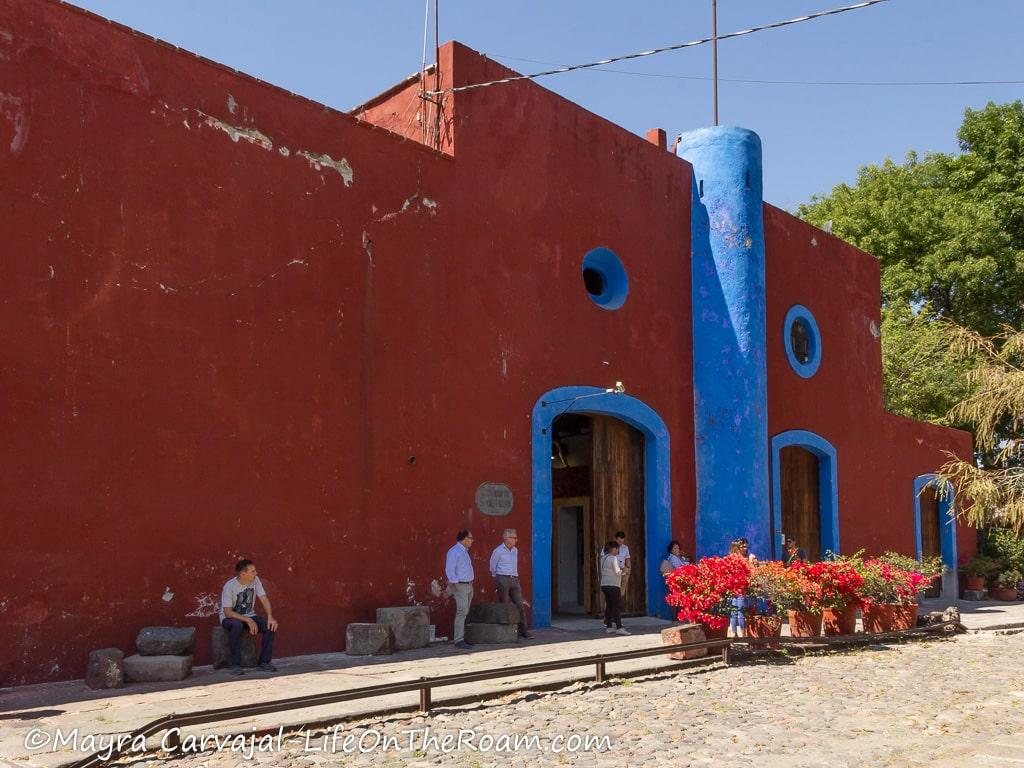 An old hacienda with a burnt red façade