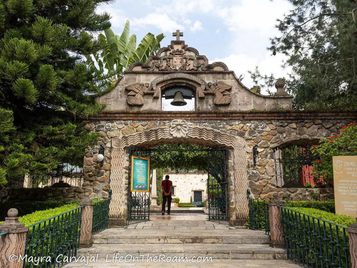 A monumental gate in stone at the entrance of a prayer centre
