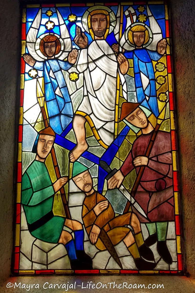 Stained glass window with religious scenes