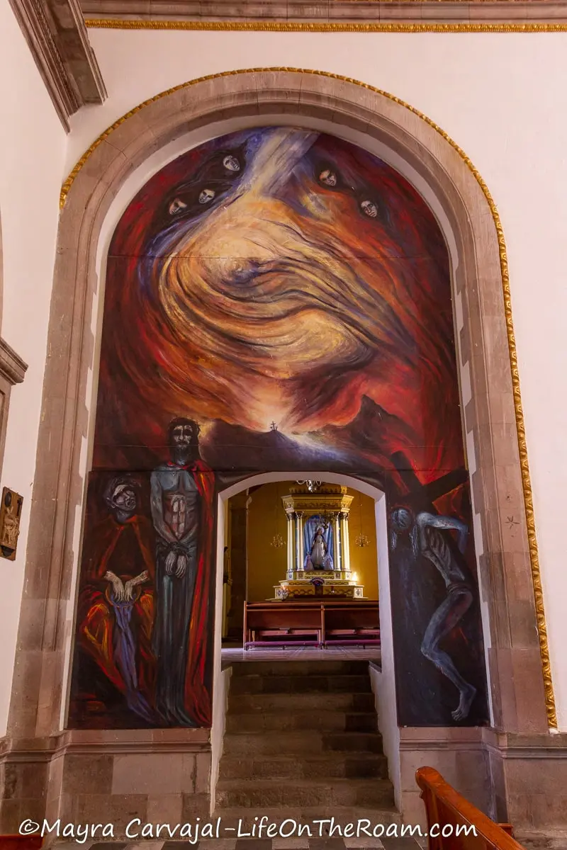 A mural in dark tones inside a church