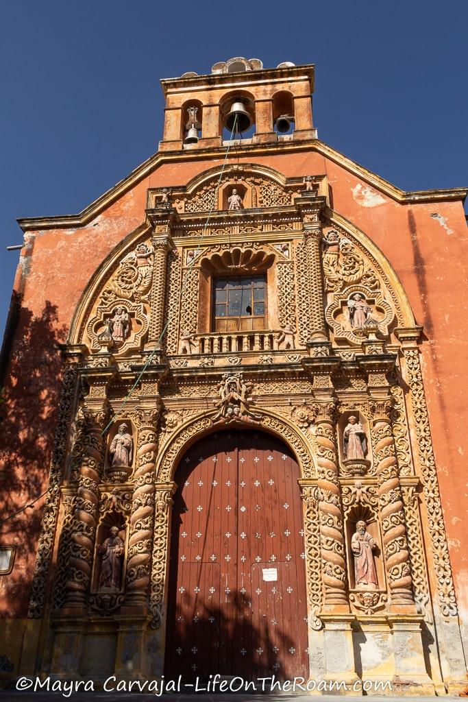 The façade of a Baroque church painted in terracotta