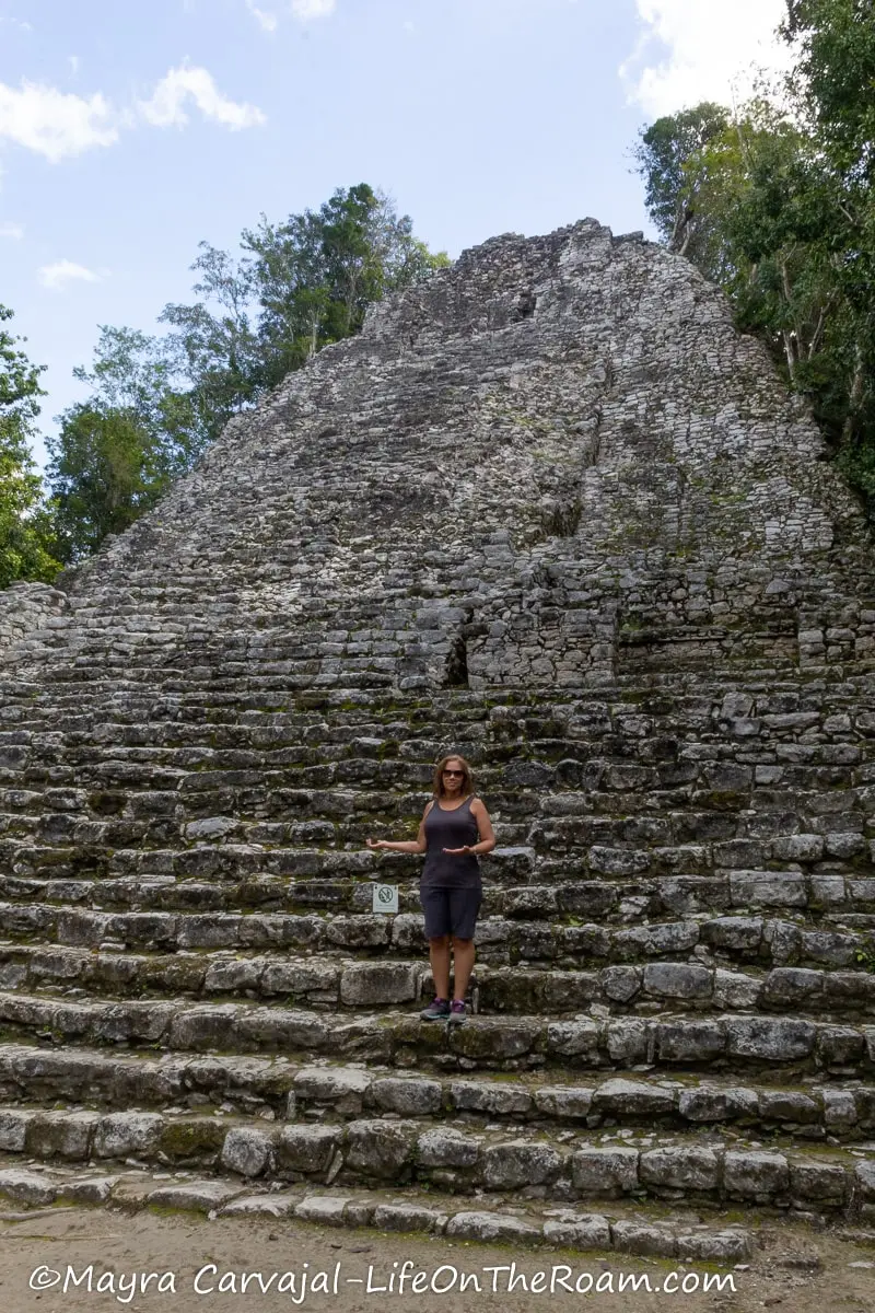 Mayra standing in front of a tall pyramid
