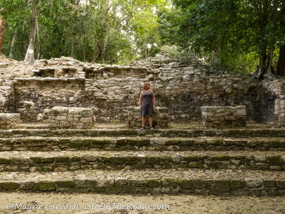 Mayra standing on a platform of an old structure