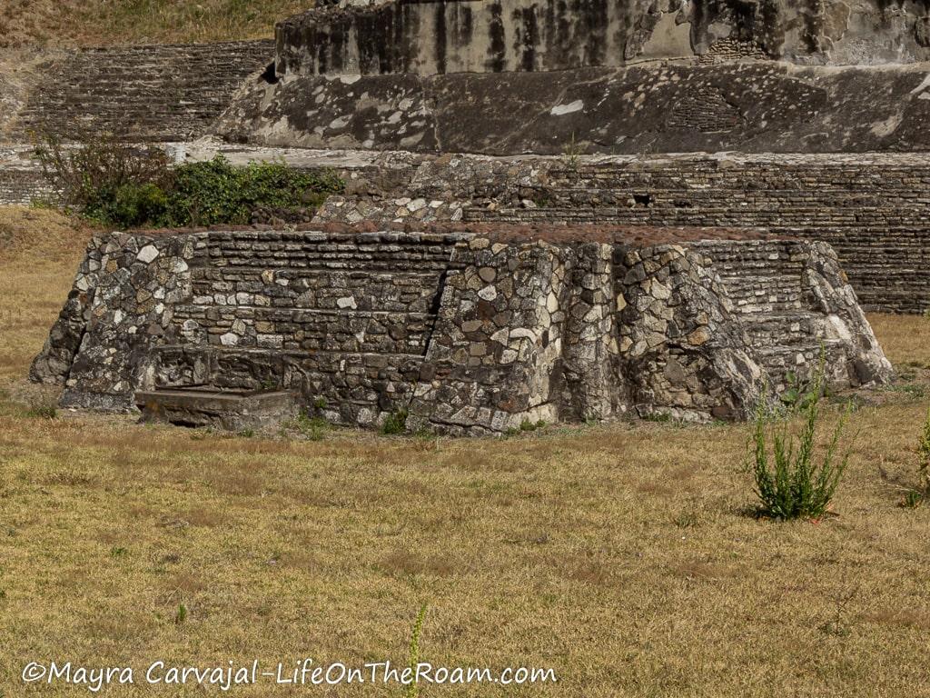 An ancient altar in front of a pyramid