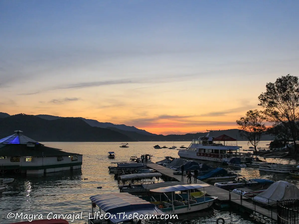 Sunset over a lake with boats