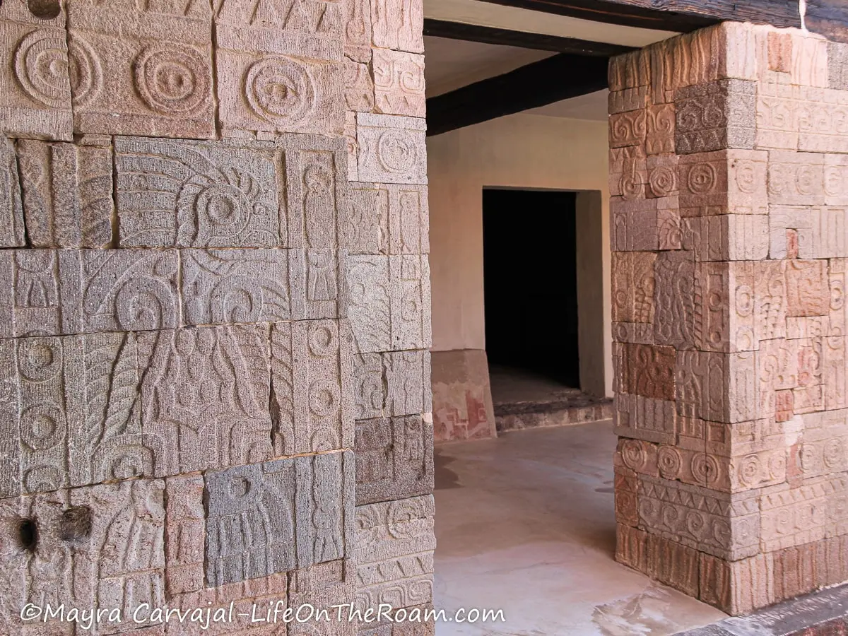 Stone columns with carving depicting birds