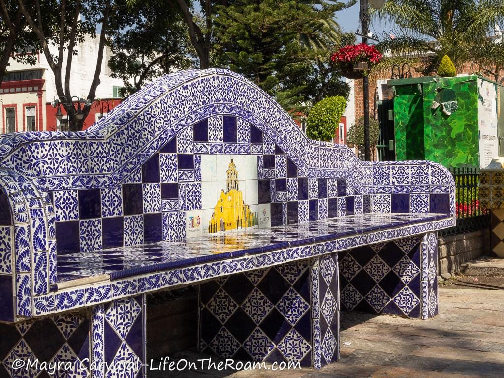 A tiled bench with blue tones in a square