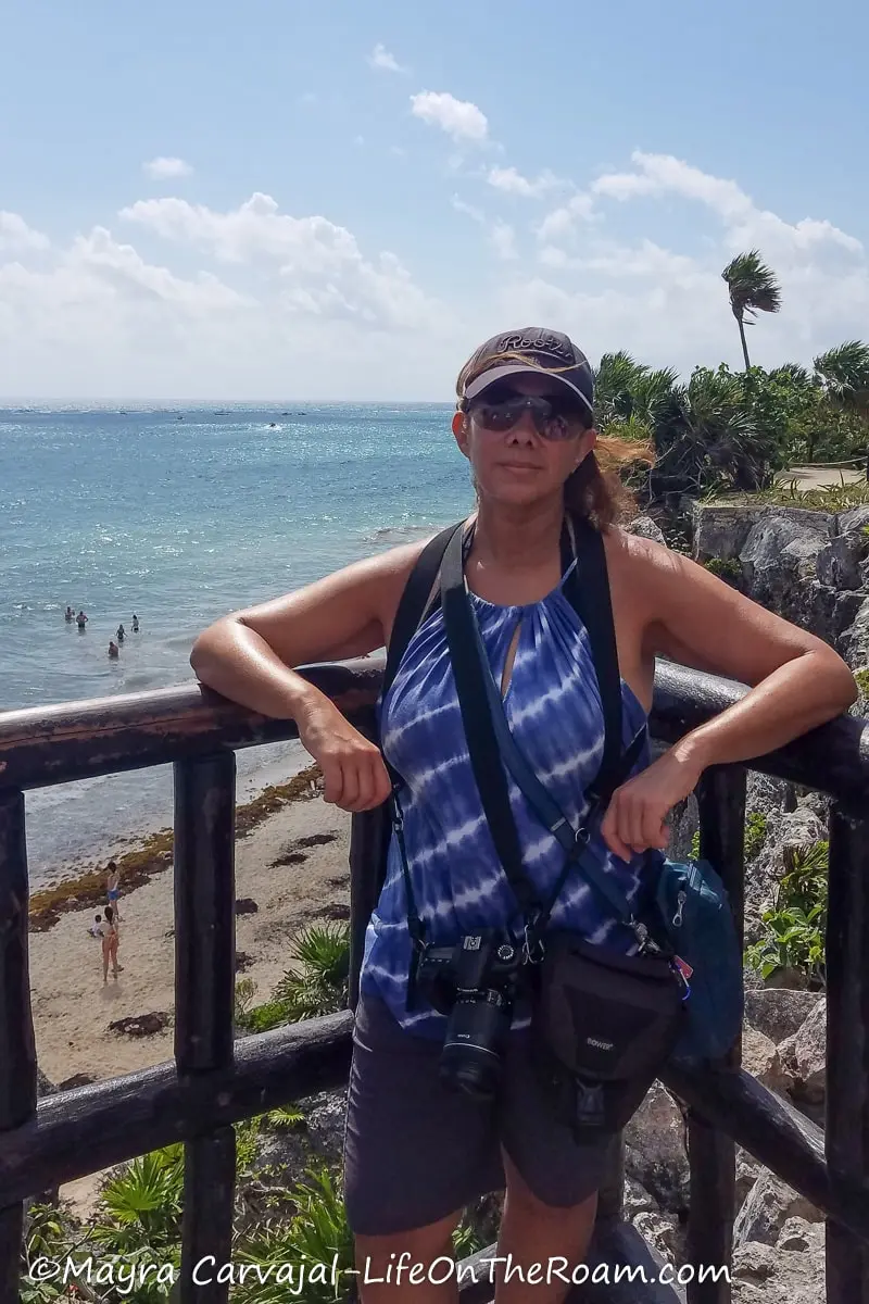 Mayra standing at an overlook with sea views from a cliff