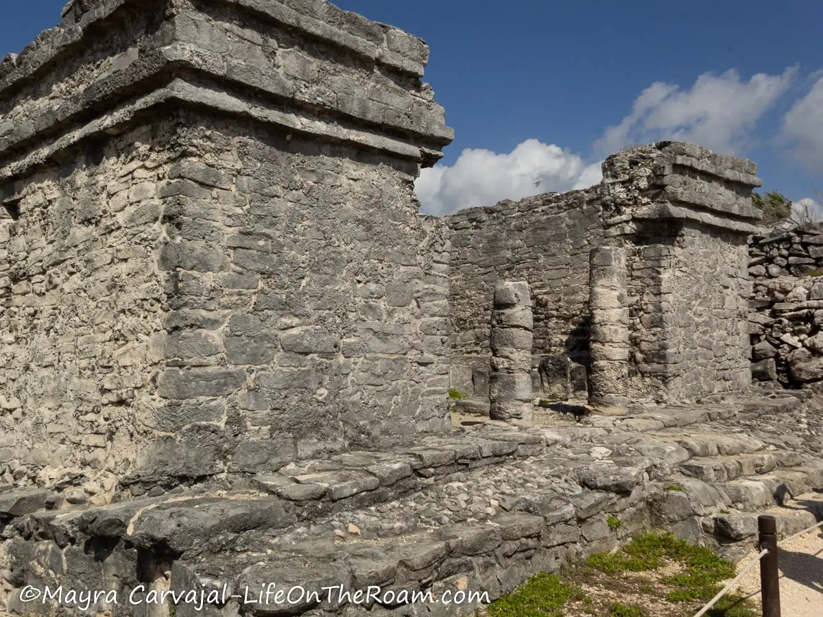 The ruins of an ancient stone house with many columns