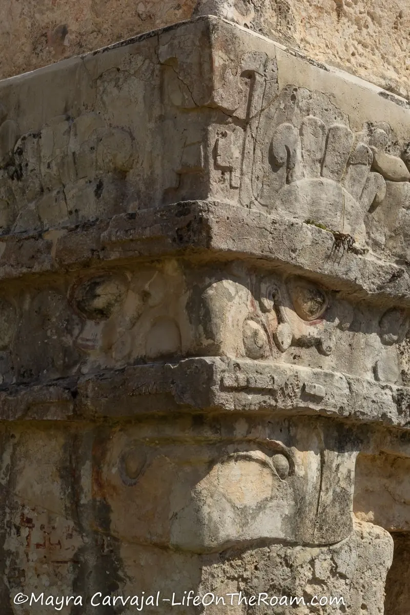 Masks carved in stucco adorning the corner of an ancient temple