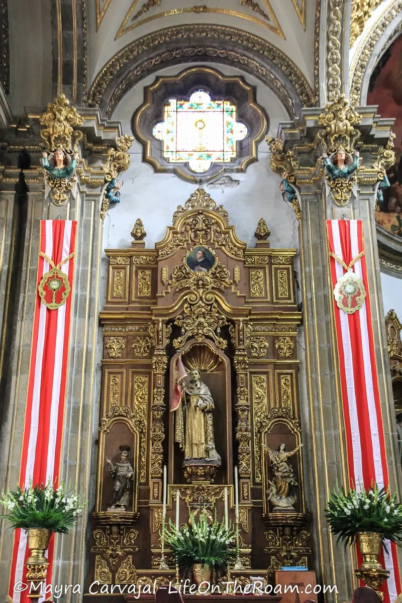 An ornate wood altar with Catholic religious figures