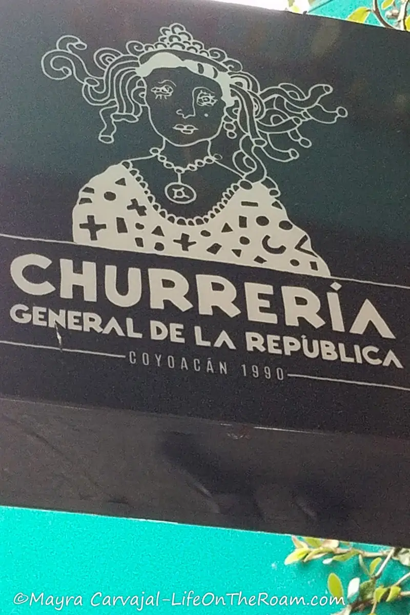 A street sign reading "Churreria General de La Republica"