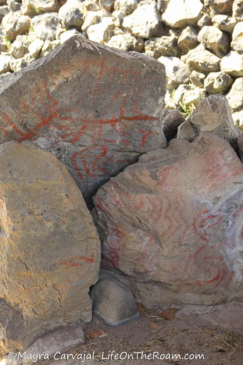 Traces of drawings made with red paint on ancient rocks