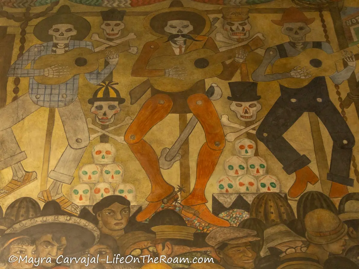 A fresco with dressed up skeletons depicting celebrations of the Day of the Dead