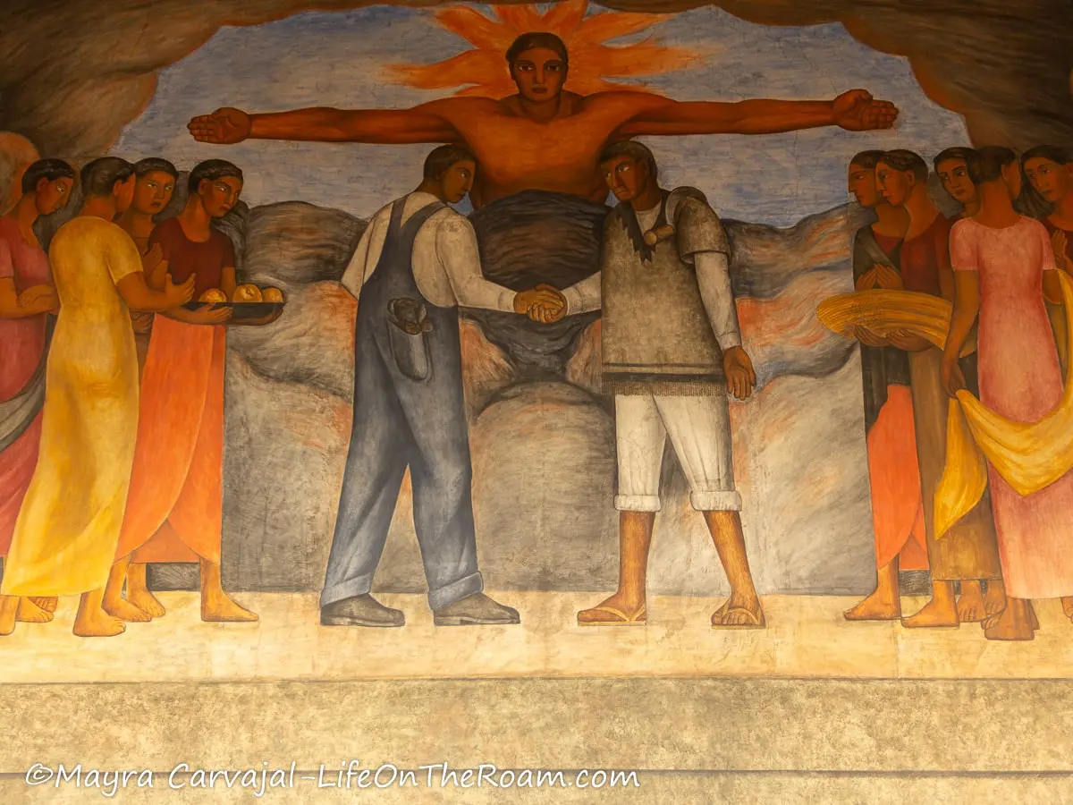 A colourful fresco with human figures shaking heads