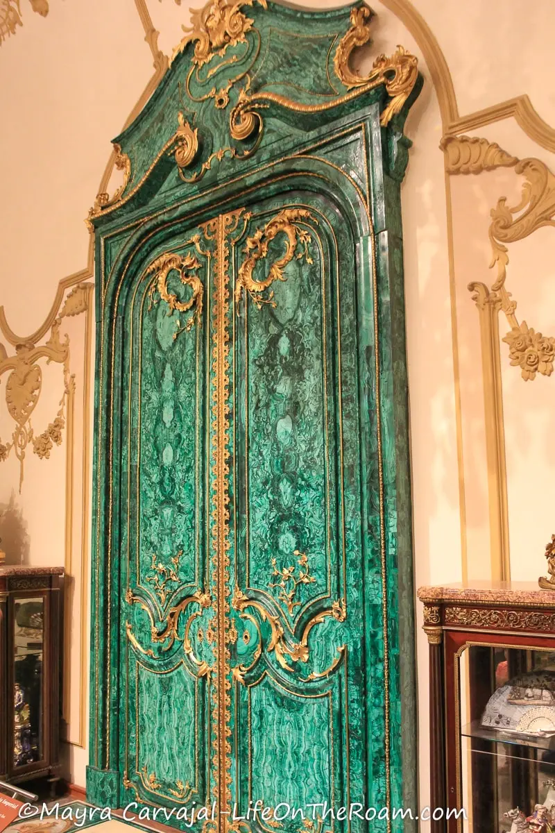A tall ornate door in malachite