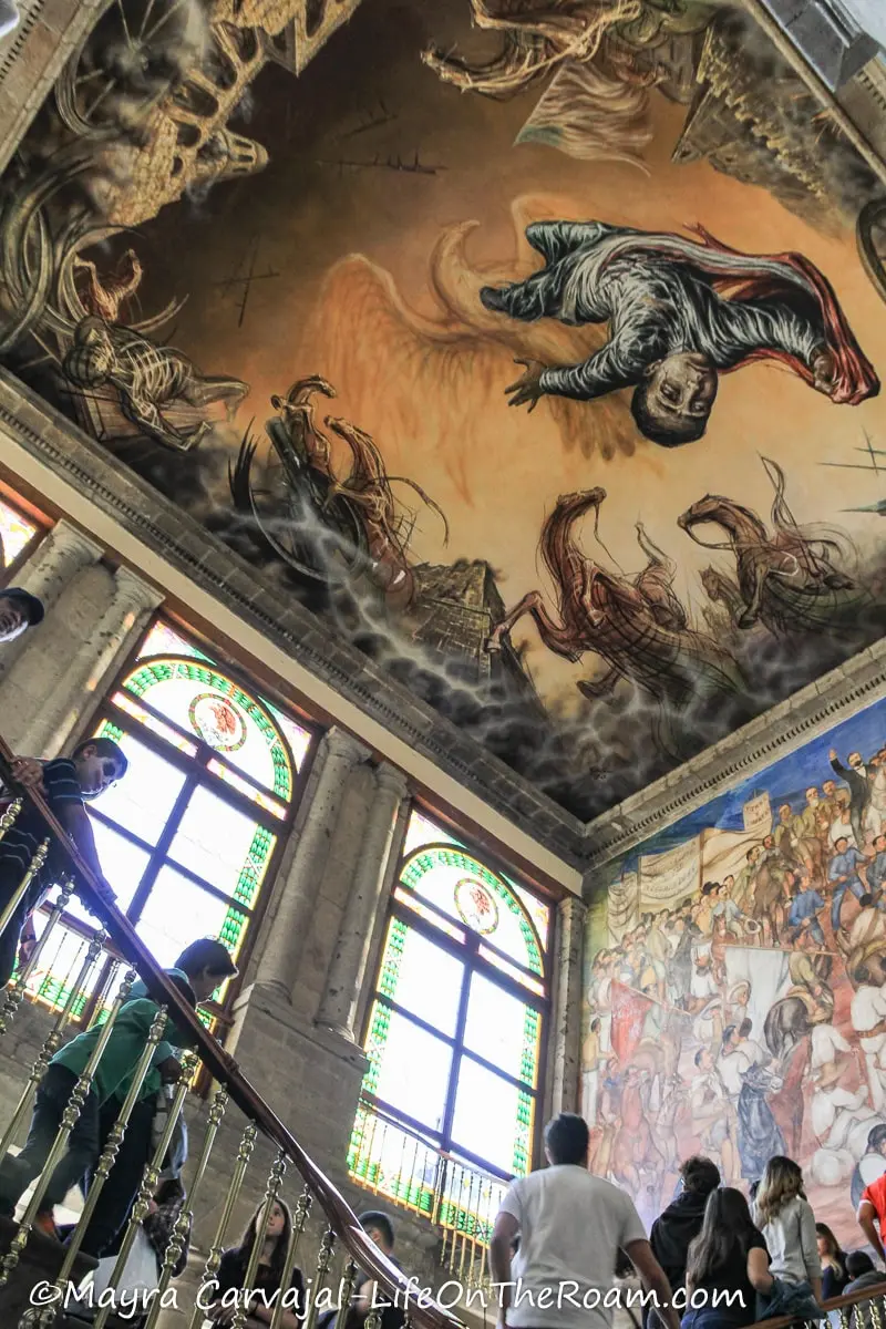 A stair in a castle under a roof with a mural